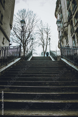 Fototapeta Naklejka Na Ścianę i Meble -  Person walking up the stairs in Paris, France