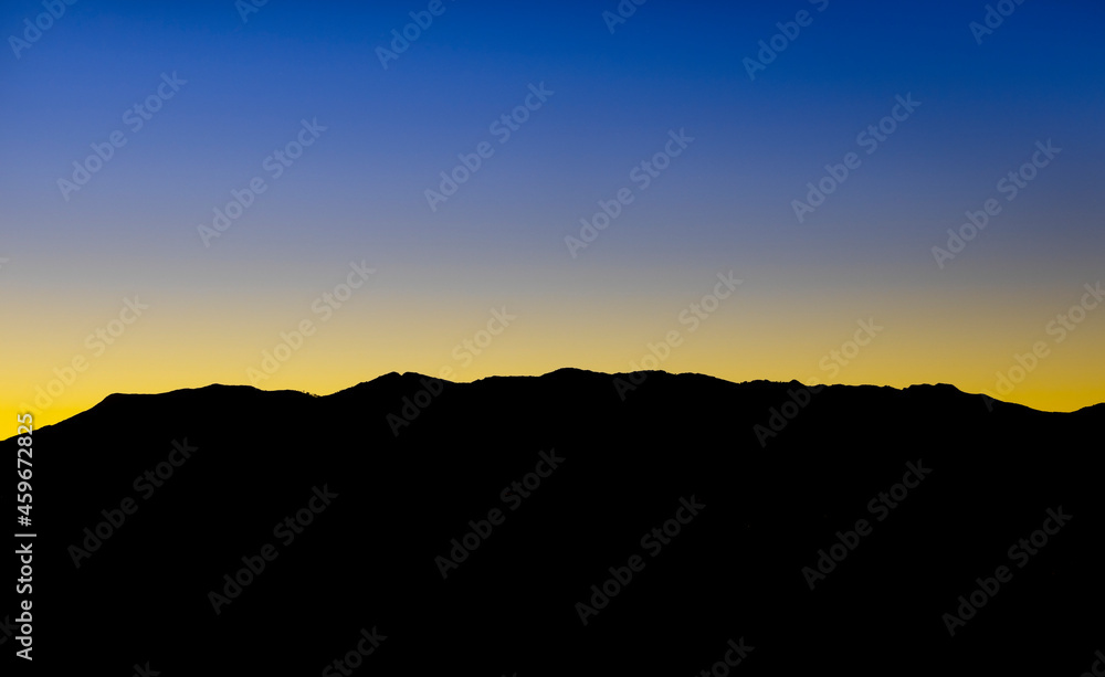 Nice sunset captured between golden hour and blue hour. The mighty dense mountains block out the sun making those beautiful colors reflect in the clean sky. Nice sunset captured between golden hour and blue hour. The mighty dense mountains block out the sun making those beautiful colors reflect in the clean sky.