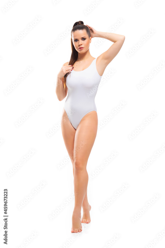 Young, fit and beautiful brunette woman in white swimsuit isolated on white background. Healthcare, diet, sport and fitness. Young, fit and beautiful brunette woman in white swimsuit isolated on white background. Healthcare, diet, sport and fitness.