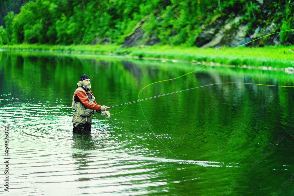 Fishing on the lake. A fisherman is fishing in the river. Fly fishing. Fishing on the lake. A fisherman is fishing in the river. Fly fishing.