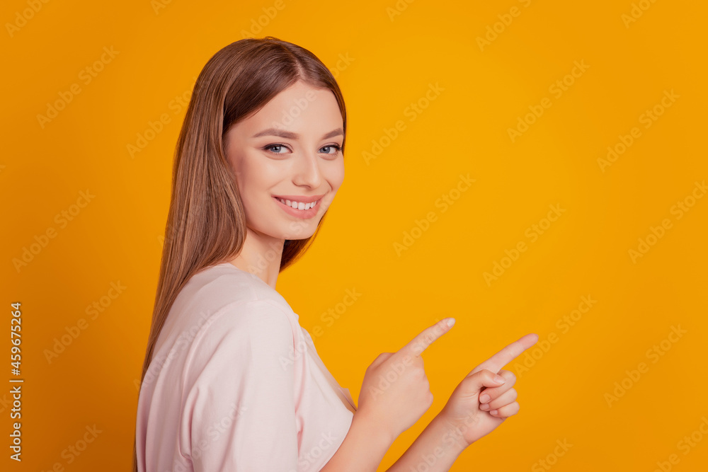 Portrait of promoter nice lady finger direct empty space on yellow background Portrait of promoter nice lady finger direct empty space on yellow background
