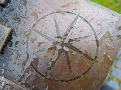 Sign of the wind rose on the monument in the park