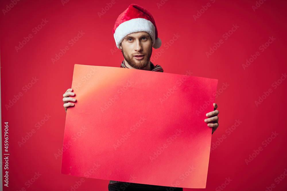 handsome man in New Year's clothes advertising copy space red background handsome man in New Year's clothes advertising copy space red background