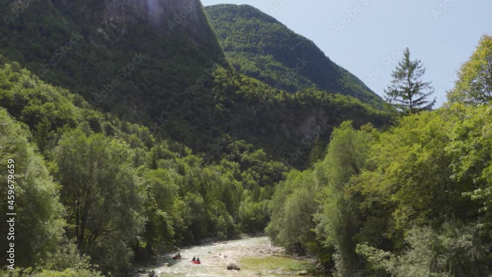 A Group of Kayakers Going Down the Soča River in Slovenia with a Dramatic Mountain Backdrop A Group of Kayakers Going Down the Soča River in Slovenia with a Dramatic Mountain Backdrop