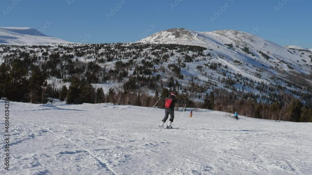 Happy Woman Skier Hands Out To Sides Simulating A Flight Skiing Down A Ski Slope Happy Woman Skier Hands Out To Sides Simulating A Flight Skiing Down A Ski Slope