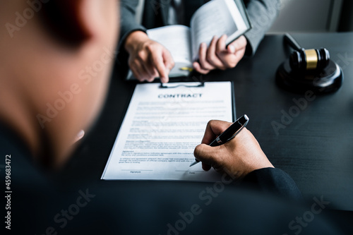 Close up of businessmen or lawyers discussing contract or business agreement at law firm office, Business people making deal document legal, justice advice service concept.