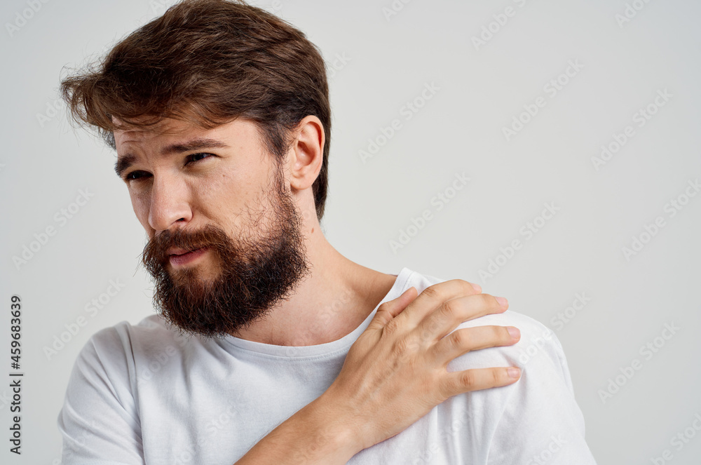 Obraz premium man pain in the neck health problems massage therapy light background