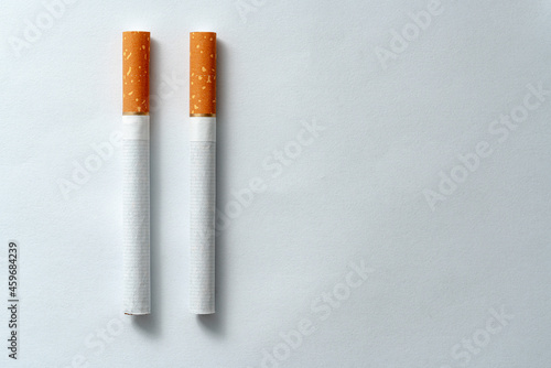 Two pieces of cigarettes evenly spaced on a white