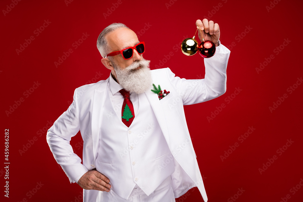 Photo of nice aged white hair santa man hold balls wear eyewear white jacket isolated on red color background