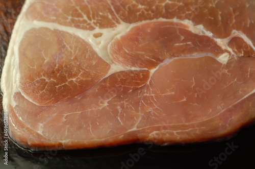 Smoked gammon steak formed from selected cuts of cured pork leg photo