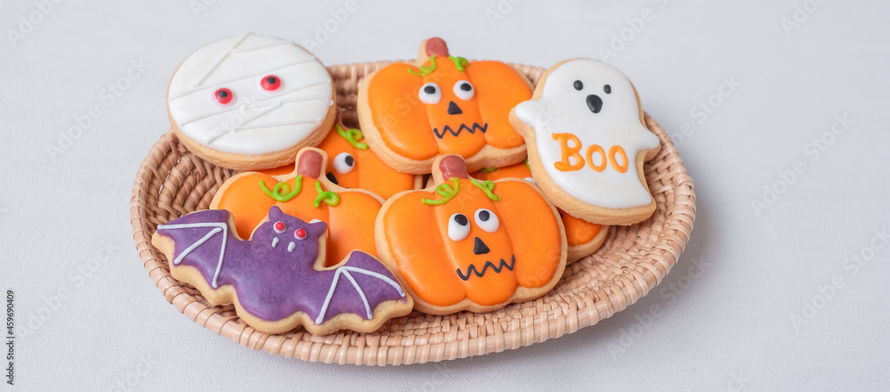 Halloween funny Cookies in wooden basket. Trick or Threat, Happy Halloween, Hello October, fall autumn, Festive, party and holiday concept Halloween funny Cookies in wooden basket. Trick or Threat, Happy Halloween, Hello October, fall autumn, Festive, party and holiday concept