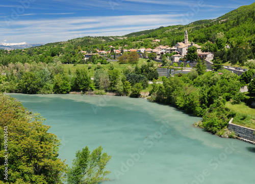 Fototapeta Naklejka Na Ścianę i Meble -  View From The Fortress Of Sisteron To The Green Shimmering River Durance And Sisteron France On A Beautiful Spring Day With A Clear Blue Sky