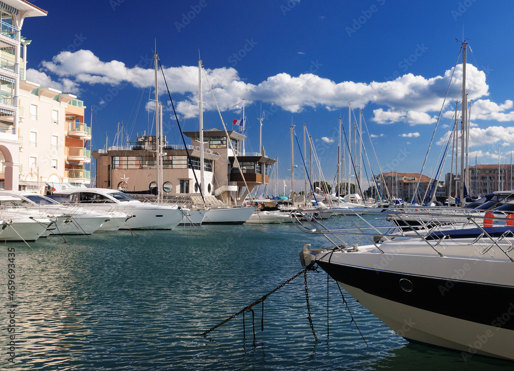 Luxurious Boats In The Yachting Harbour Of Frejus In France On A Beautiful Spring Day With Some Fluffy Clouds In The Clear Blue Sky