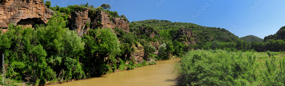 Red Rocks At The River Argens Near Roquebrune In Provence France On A Beautiful Summer Day With A Clear Blue Sky Red Rocks At The River Argens Near Roquebrune In Provence France On A Beautiful Summer Day With A Clear Blue Sky