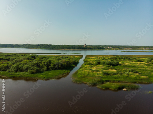 Onega river channel. Canal for boats. High wooden temple on the mountain. Russia  Arkhangelsk region  Podporozhye 