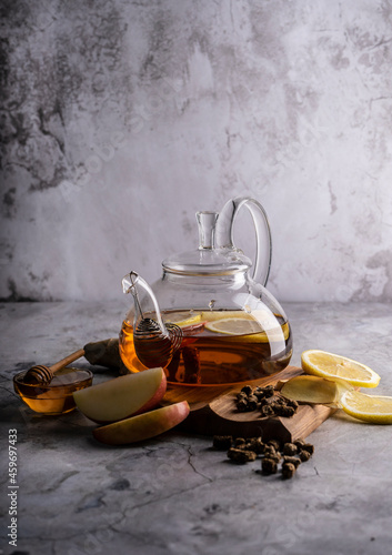 selective focus, freshly brewed tea in a transparent teapot, with fruits and fresh berries. leaf tea and spices. still-life. for advertising and menus