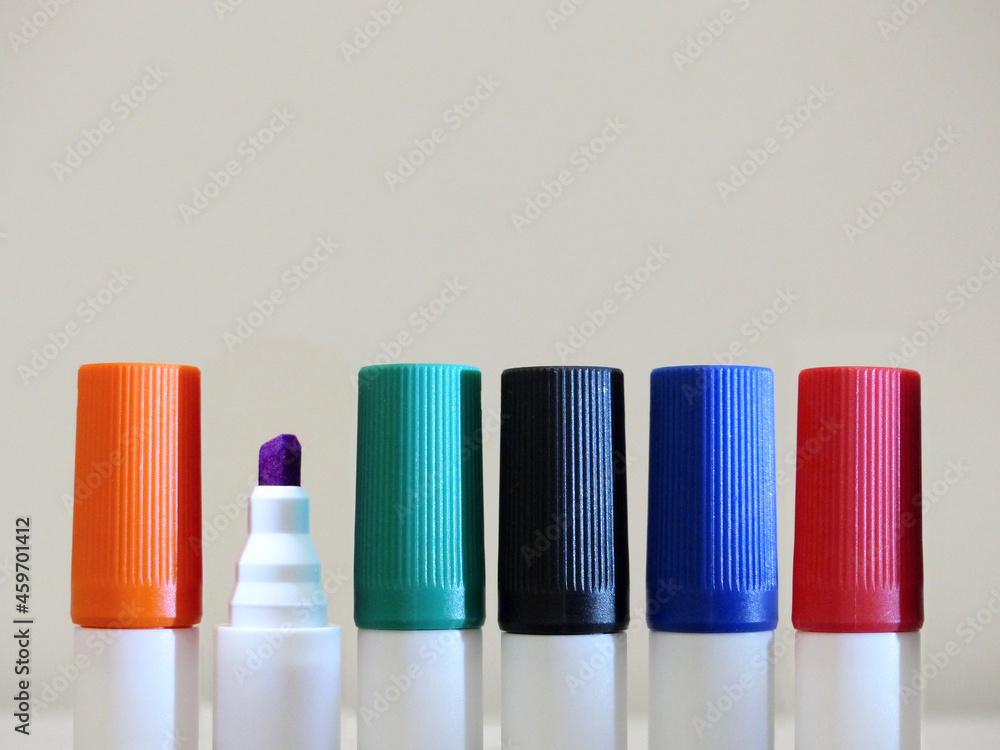 6 perfectly aligned in a row, colorful felt-tip pens (markers for whiteboards). One of them, (purple colored) has no protective cap. (orange, purple, green, black, blue, red) 6 perfectly aligned in a row, colorful felt-tip pens (markers for whiteboards). One of them, (purple colored) has no protective cap. (orange, purple, green, black, blue, red)