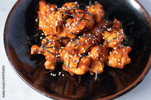 Fried chicken with Korean spicy sauce topped with seaweed