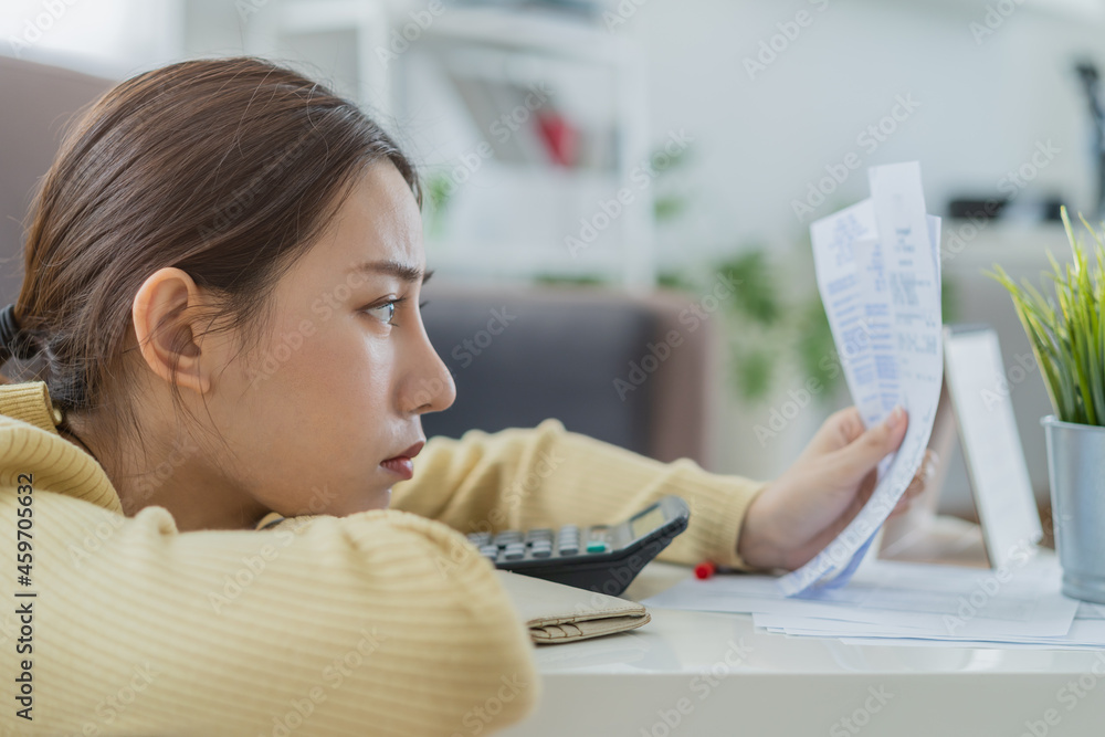 Owe, problem asian woman, female broke sitting on floor at home stressed and confused by calculate expense from invoice or bill, no money pay, mortgage or loan. Debt, bankruptcy or bankrupt concept. Owe, problem asian woman, female broke sitting on floor at home stressed and confused by calculate expense from invoice or bill, no money pay, mortgage or loan. Debt, bankruptcy or bankrupt concept.