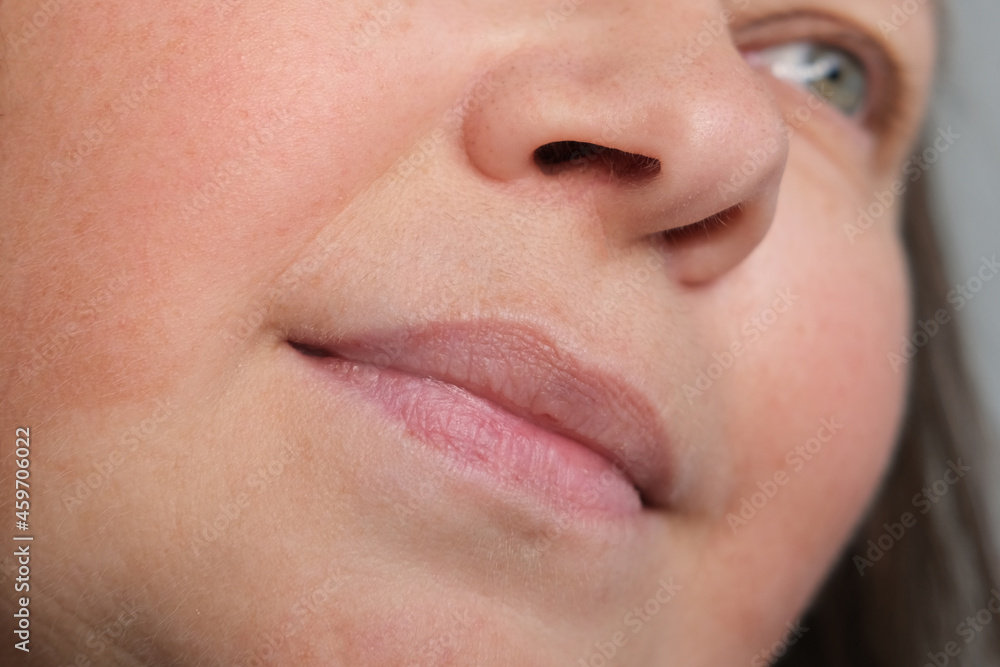 close-up of part of face of middle-aged woman 45-50 years, small wrinkles on skin, around lips, concept of anti-aging procedures, facial massage, before cosmetic procedures close-up of part of face of middle-aged woman 45-50 years, small wrinkles on skin, around lips, concept of anti-aging procedures, facial massage, before cosmetic procedures