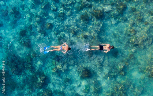 The people are snorkeling near the famous place on Gili Meno Island, Indonesia. Aerial view. Underwater tourism in the ocean. Gili Meno Island, Indonesia. Travel - image