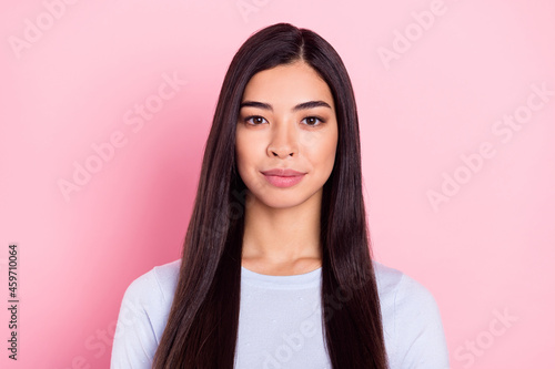 Photo portrait of serious brunette wearing blue sweatshirt isolated on pastel pink color background