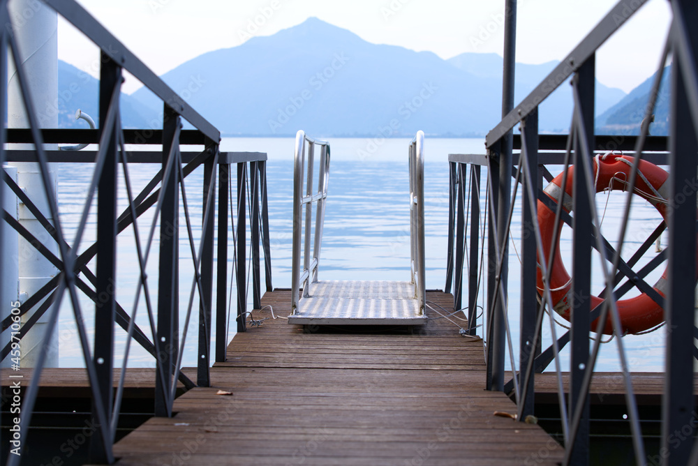 Fototapeta premium Close-up of wooden pier at Lake Lugano on a late summer morning. Photo taken September 11th, 2021, Lugano, Switzerland.