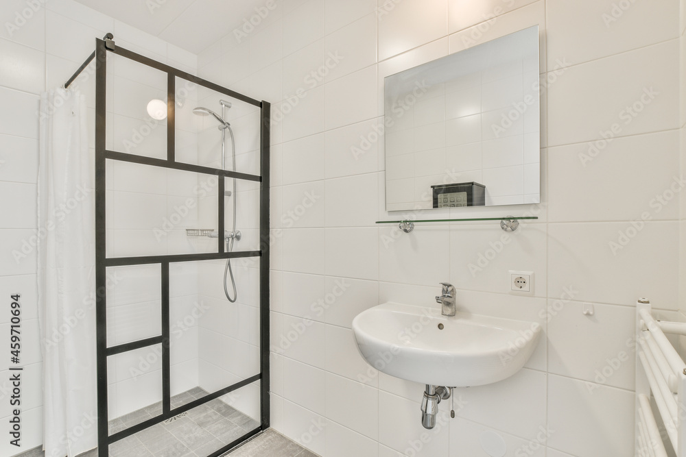 Interior of light bathroom with shower cabin and sink Interior of light bathroom with shower cabin and sink