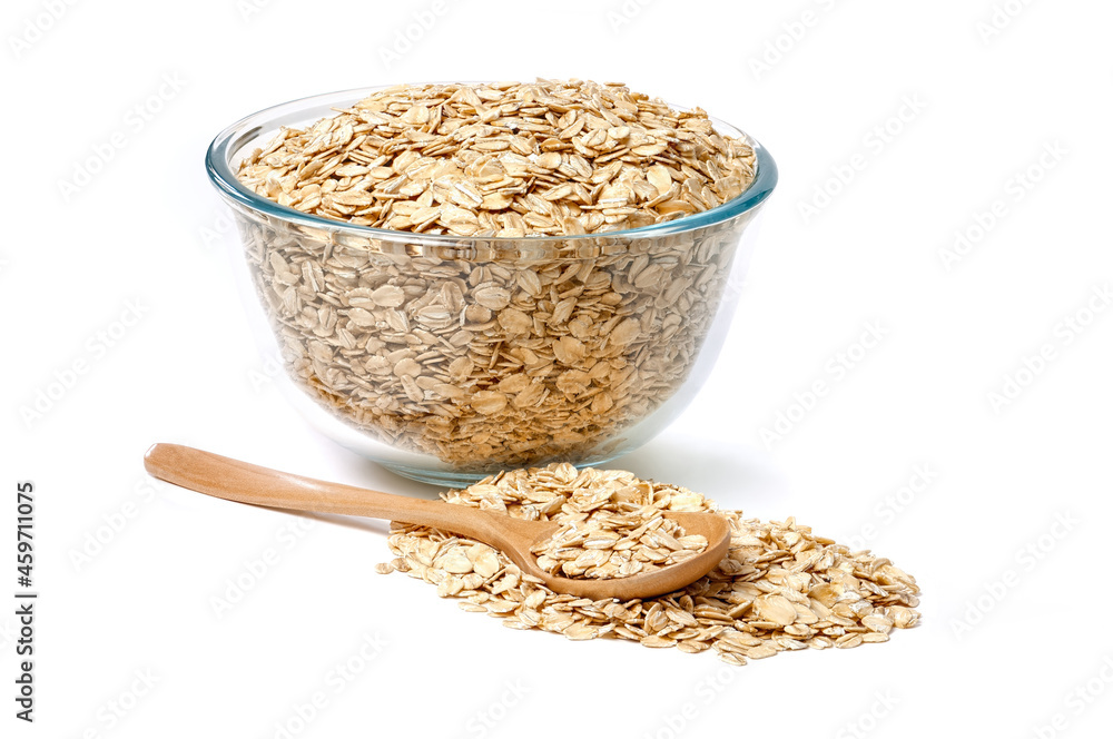 Oat flakes in glass bowl and wooden spoon isolated on white background. Oat flakes in glass bowl and wooden spoon isolated on white background.
