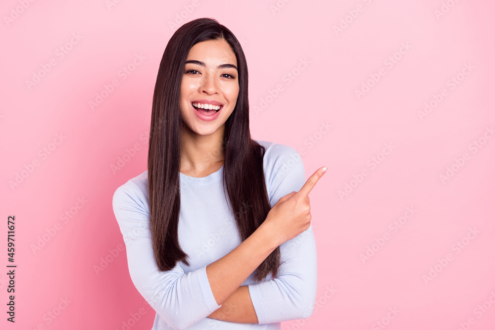 Photo portrait of girl laughing pointing finger recommending copyspace isolated on pastel pink color background Photo portrait of girl laughing pointing finger recommending copyspace isolated on pastel pink color background