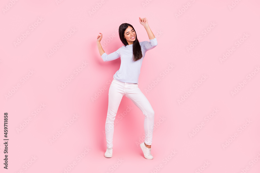 Full length body size view of attractive dreamy cheerful girl dancing having fun rest pastime isolated over pink pastel color background Full length body size view of attractive dreamy cheerful girl dancing having fun rest pastime isolated over pink pastel color background