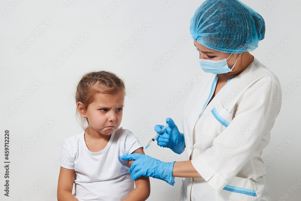 Female doctor injecting vaccine to girl Female doctor injecting vaccine to girl