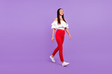 Profile photo of positive carefree charming lady enjoy walk wear white blouse pants isolated violet color background