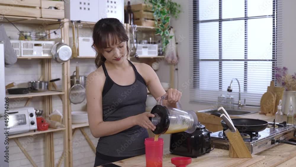 Wais Up Japanese Athletic Female Pouring Juice From Blender And
