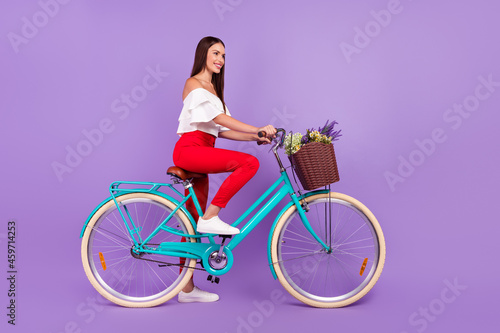 Fototapeta Naklejka Na Ścianę i Meble -  Profile photo of dream girlfriend lady ride bicycle wear white blouse pants isolated violet color background