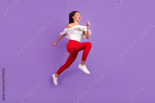Profile photo of sporty energetic lady jump run wear white blouse trousers footwear isolated purple color background