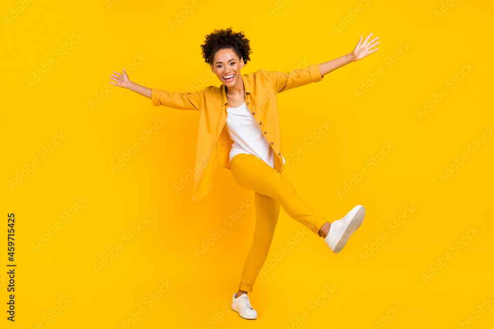Full length body size photo woman laughing dancing at disco isolated vivid yellow color background