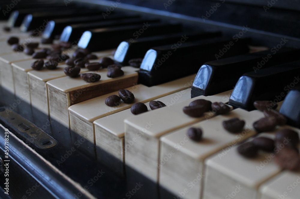 coffee beans on the piano. coffee beans lie beautifully on the piano keyboard. coffee and piano coffee beans on the piano. coffee beans lie beautifully on the piano keyboard. coffee and piano