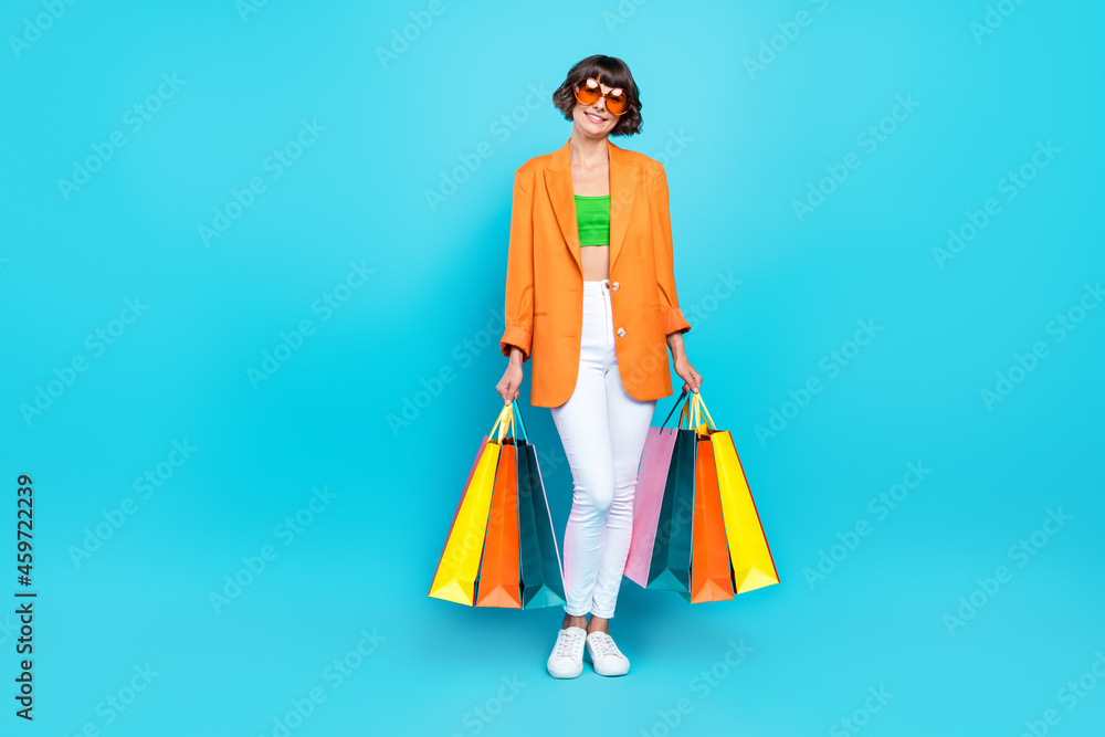 Full body photo of happy cheerful woman shopping bags good mood smile isolated on pastel blue color background