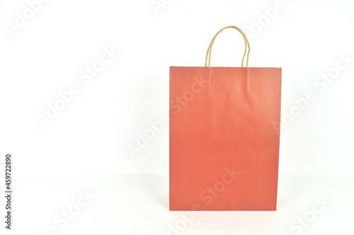 Red paper shopping bags on white background