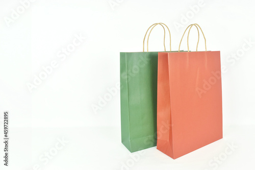 Colorful paper shopping bags on white background with copy space.