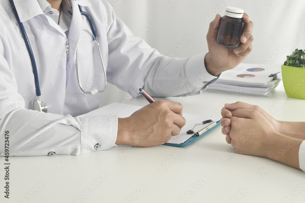 Physician consulting his patient at clinic. Physician consulting his patient at clinic.