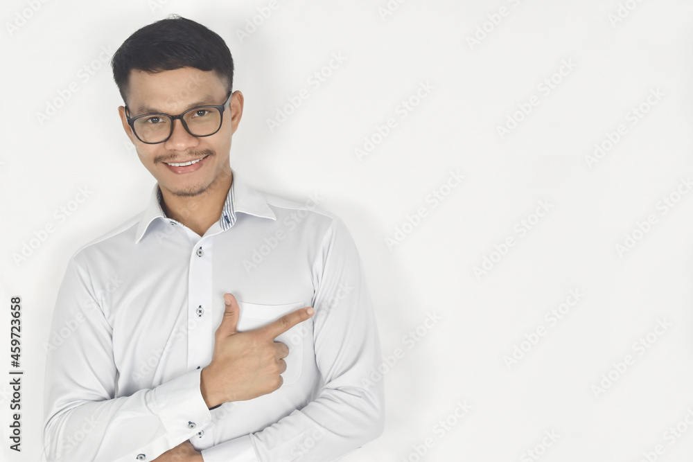 Portrait of a smiling young man pointing his finger on the side Portrait of a smiling young man pointing his finger on the side