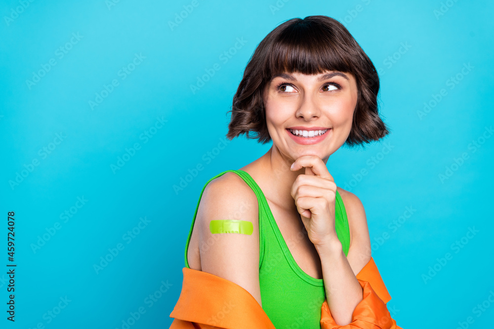 Photo of happy dreamy woman look empty space shoulder vaccine minded isolated on blue color background