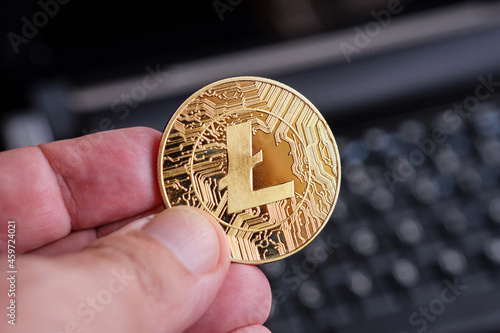 Litecoin cryptocurrency and laptop photo