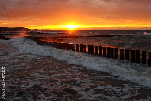 Fototapeta Naklejka Na Ścianę i Meble -  Beautiful sunset over the sea with red reflexes on clouds 