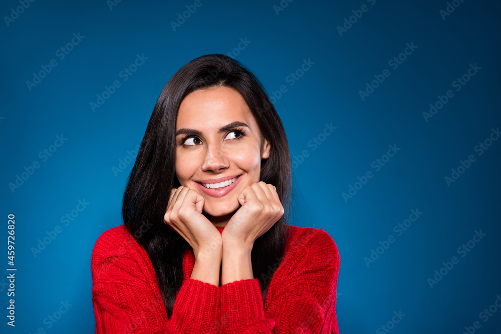 Photo portrait of smiling woman looking empty space dreamy isolated on dark blue color background Photo portrait of smiling woman looking empty space dreamy isolated on dark blue color background