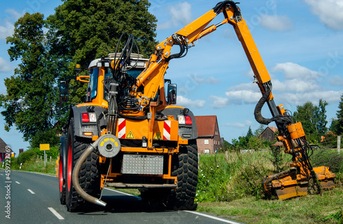 Maintenance of the edge of a road by a brush cutter tractor.