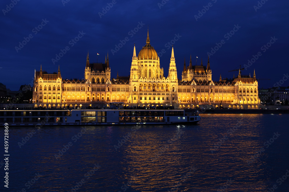 Budapest Parliament building at night on the Danube river in Hungary