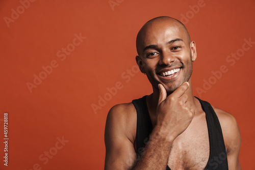 Black young man wearing shirt smiling and looking at camera